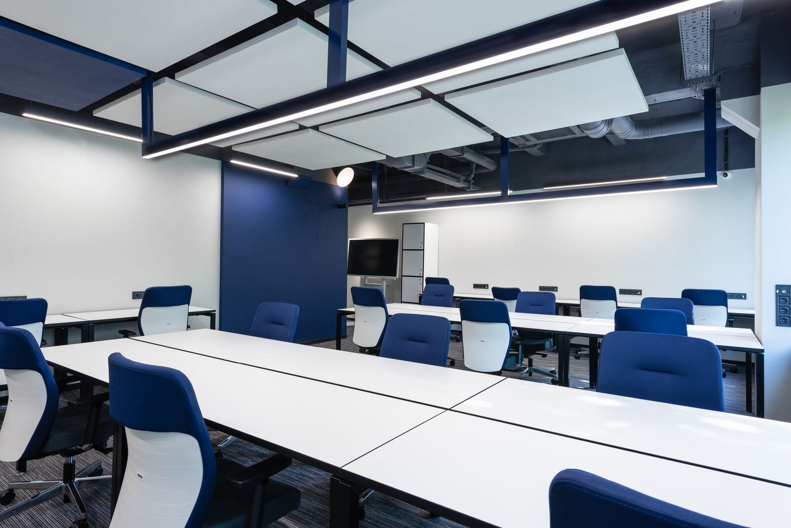 Renovated office interior with navy chairs and new finishes