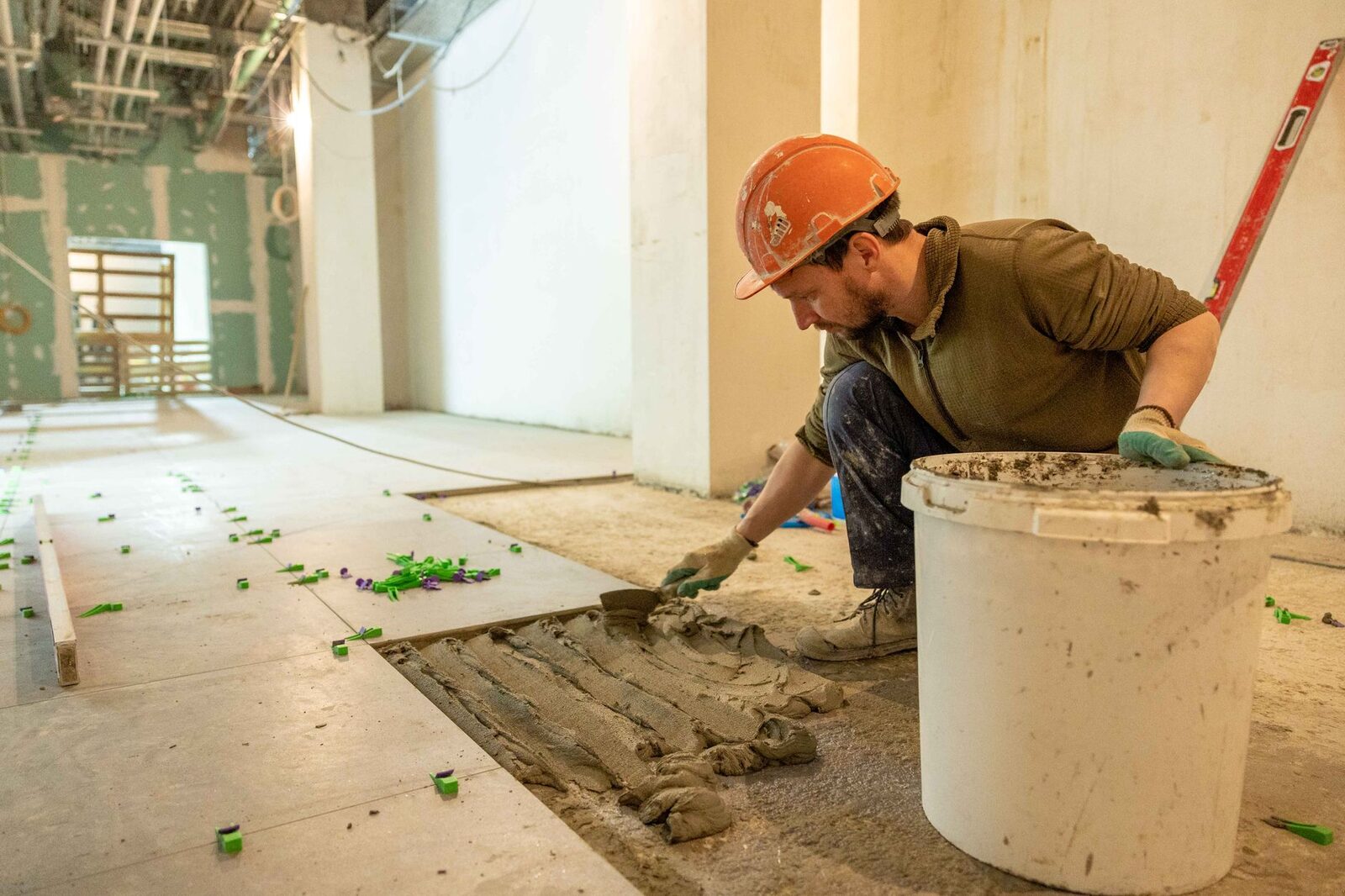 Tile setter working on a commercial floor