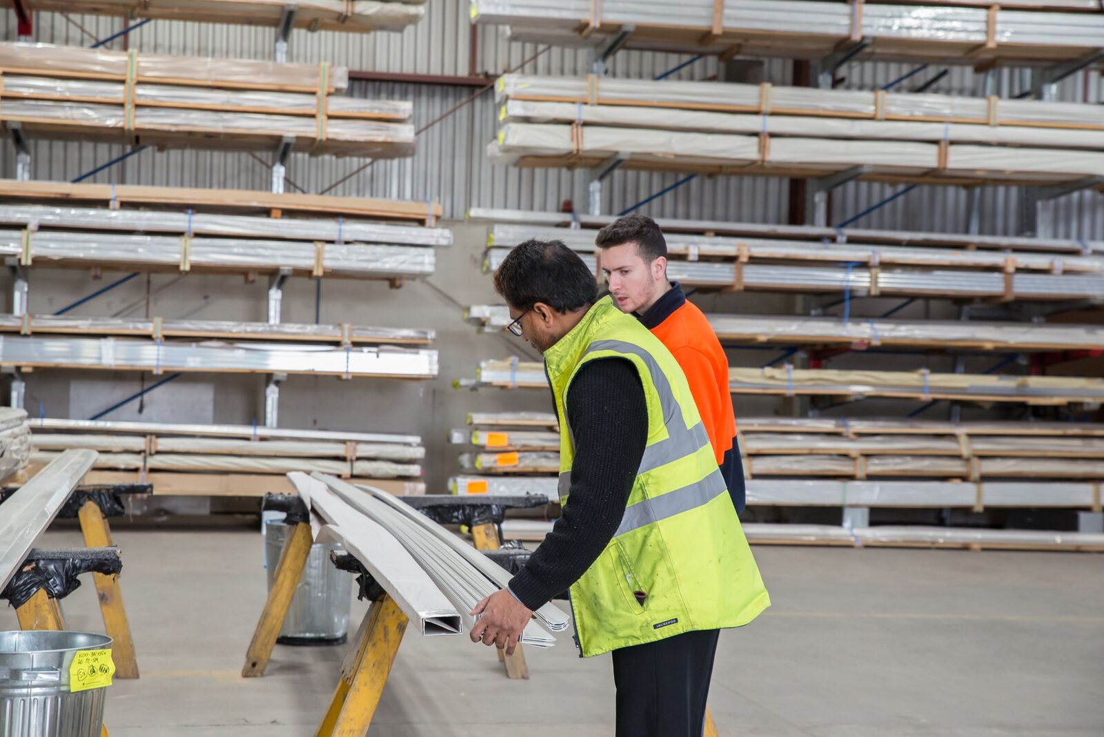 Two workers reviewing materials at a commercial site